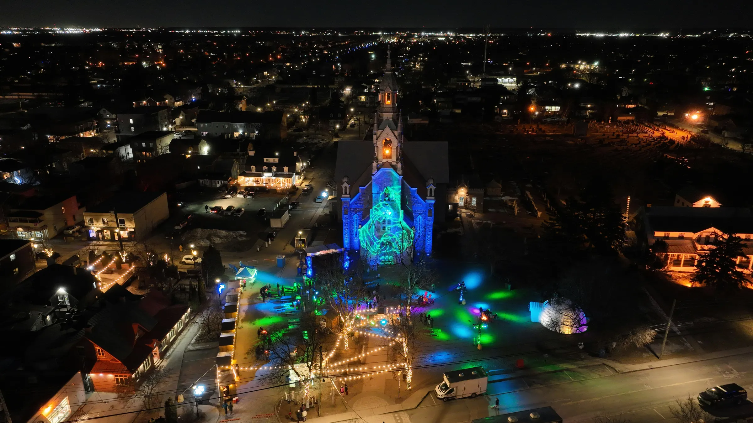 an aerial view of a church lit up at night