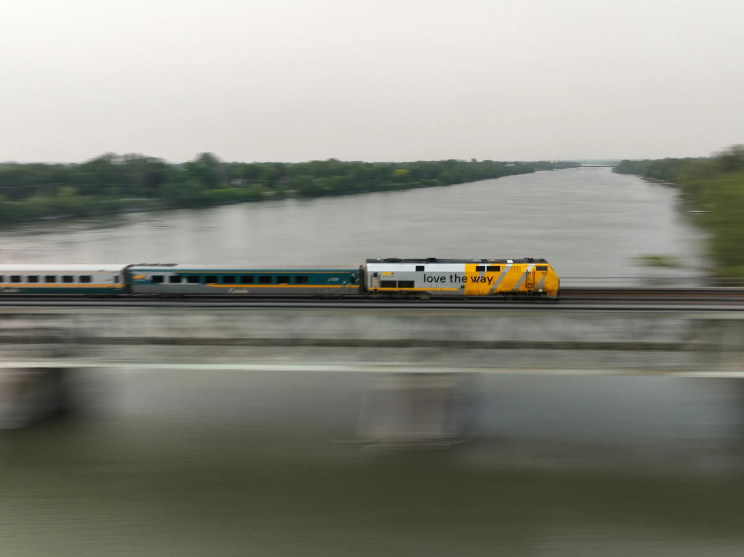 a train traveling over a bridge next to a river