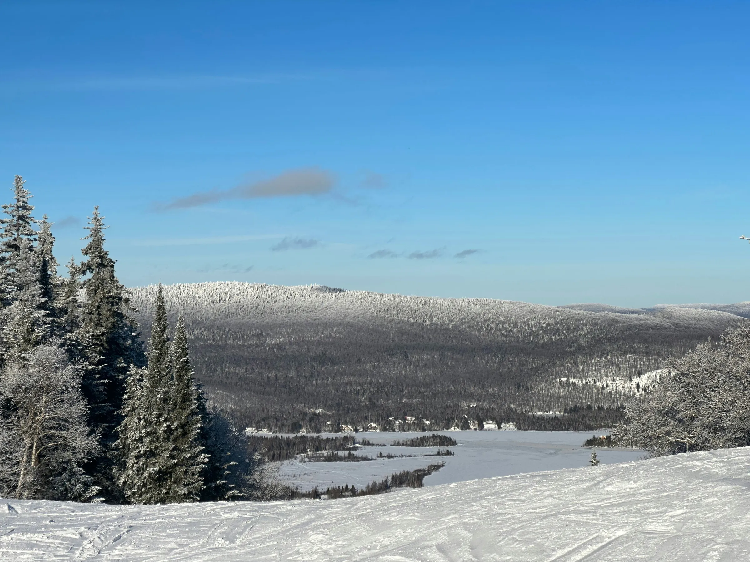 a person riding skis on top of a snow covered slope